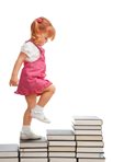 toddler climbs stairs made of books