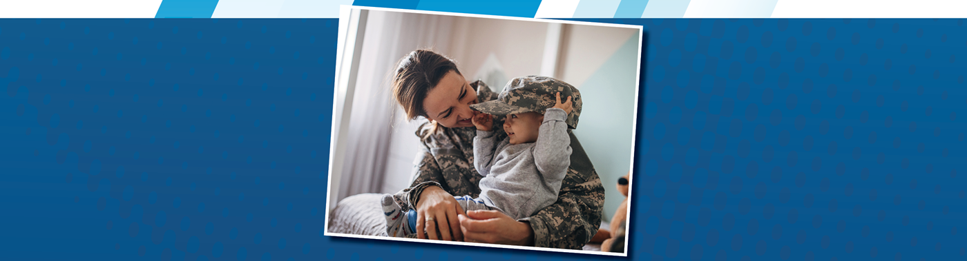 A soldier and their toddler have a moment playing with the parent's campflage hat