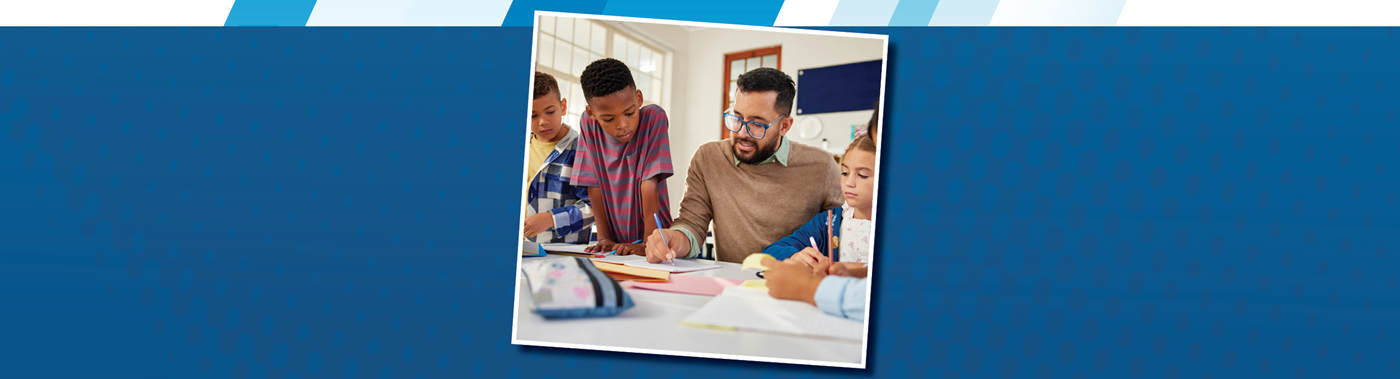 teacher working with a small group of students at a table