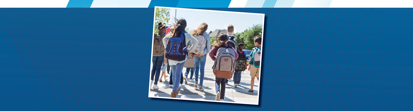 group of children with backpacks walking away