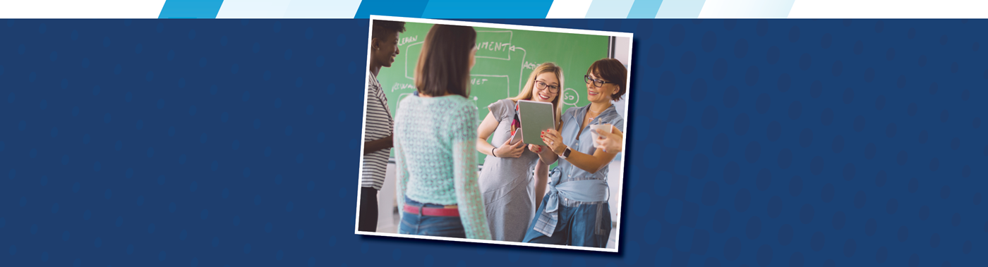 a teacher and teens doing an activity in class