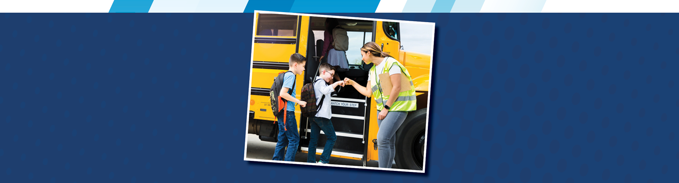 a bus driver giving a student a fist bump as they get on the bus