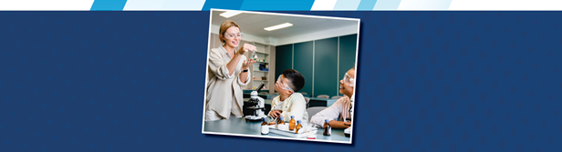 A teacher works with a student in a lab.