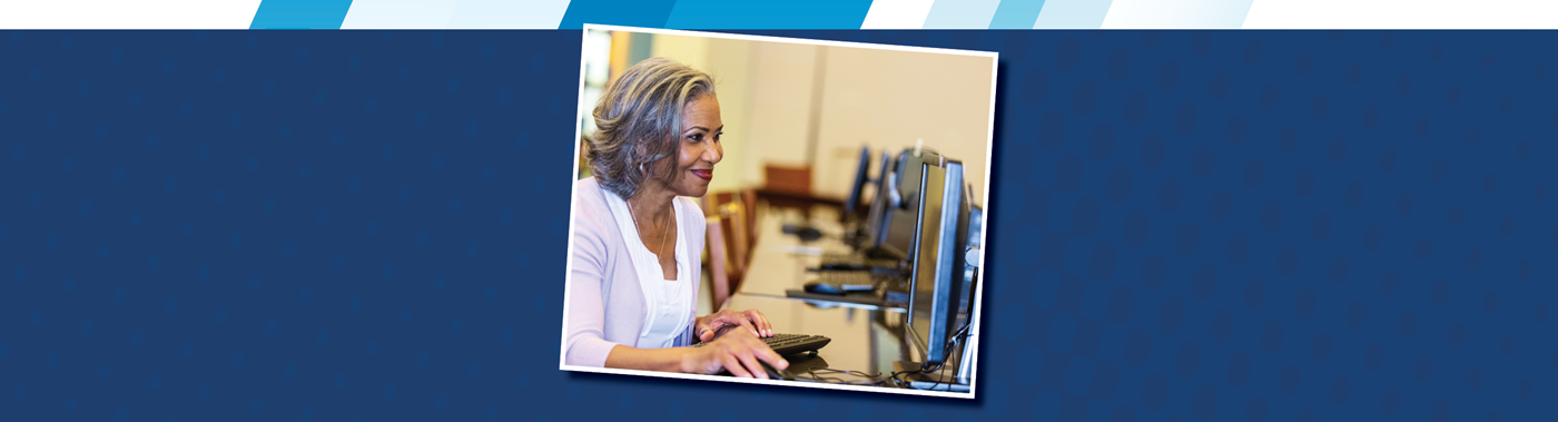 A woman uses a computer in a computer lab.