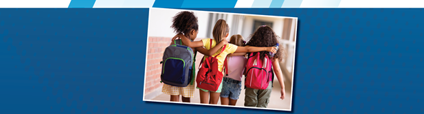 Three girls walking down a hallway with their arms around each others shoulders