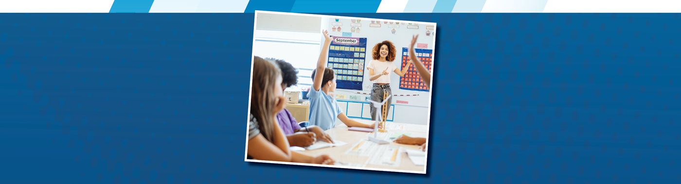 teacher in a classroom of older elementary students. a couple of students have their hands raised