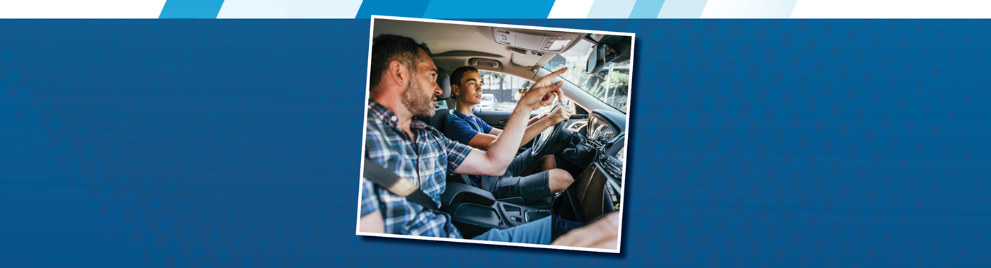 a parent showing their teen how to use the rearview mirror
