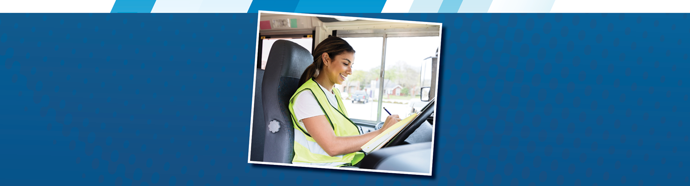 a parked bus driver writing in a notebook