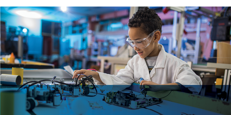In-Demand-Jobs-Week5.png Tween boy with short curly hair and goggles doing a STEM activity