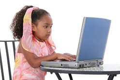 little girl using a laptop