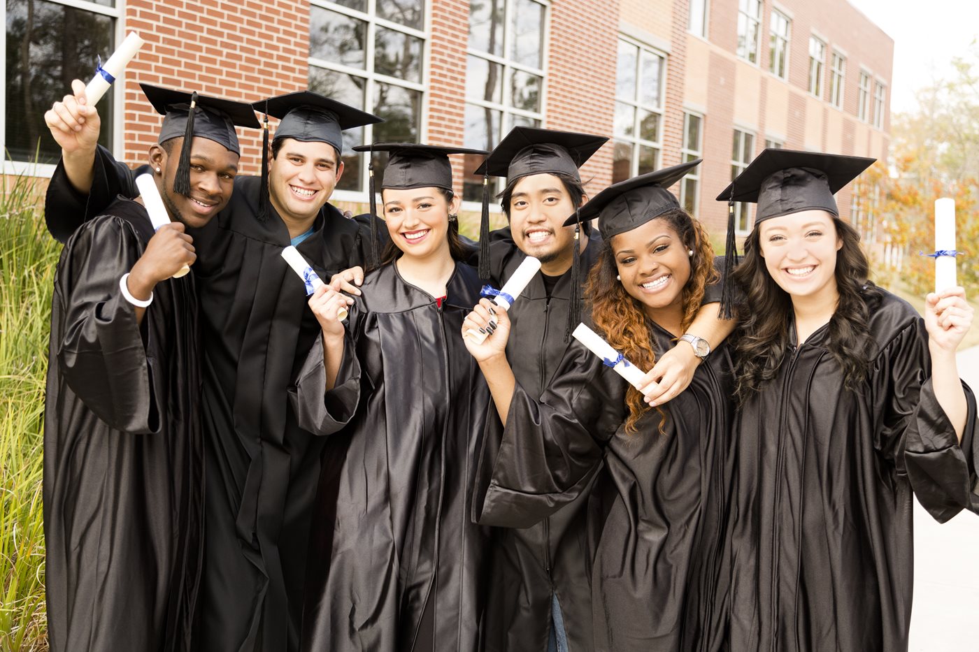Multi-ethnic friends excited after graduation