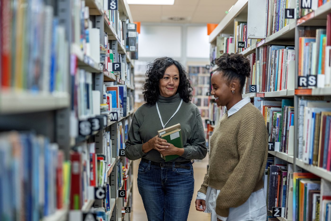 Two female educators in library