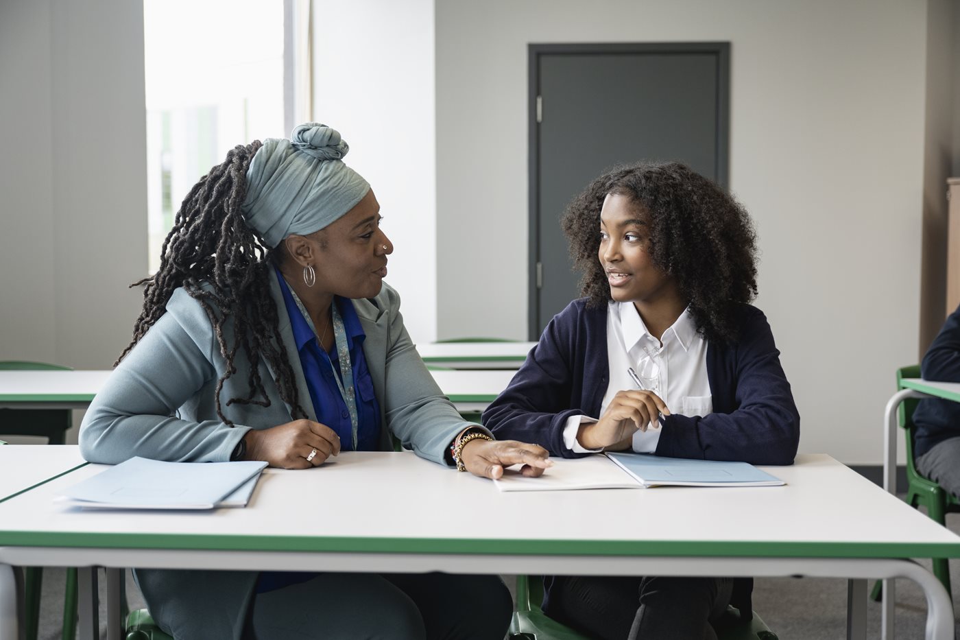 Black educator working with multiracial student