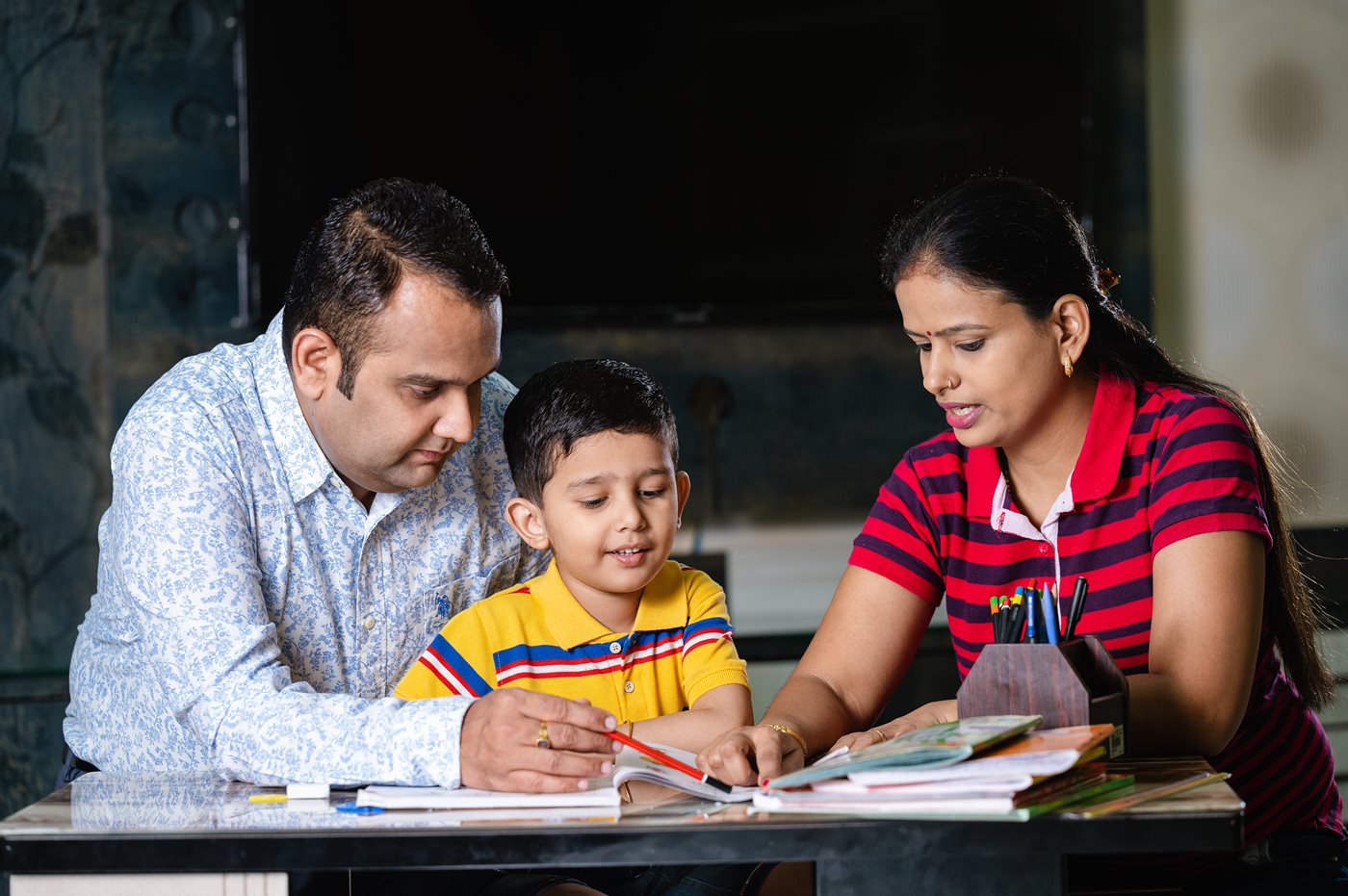 Parents reviewing homework with son