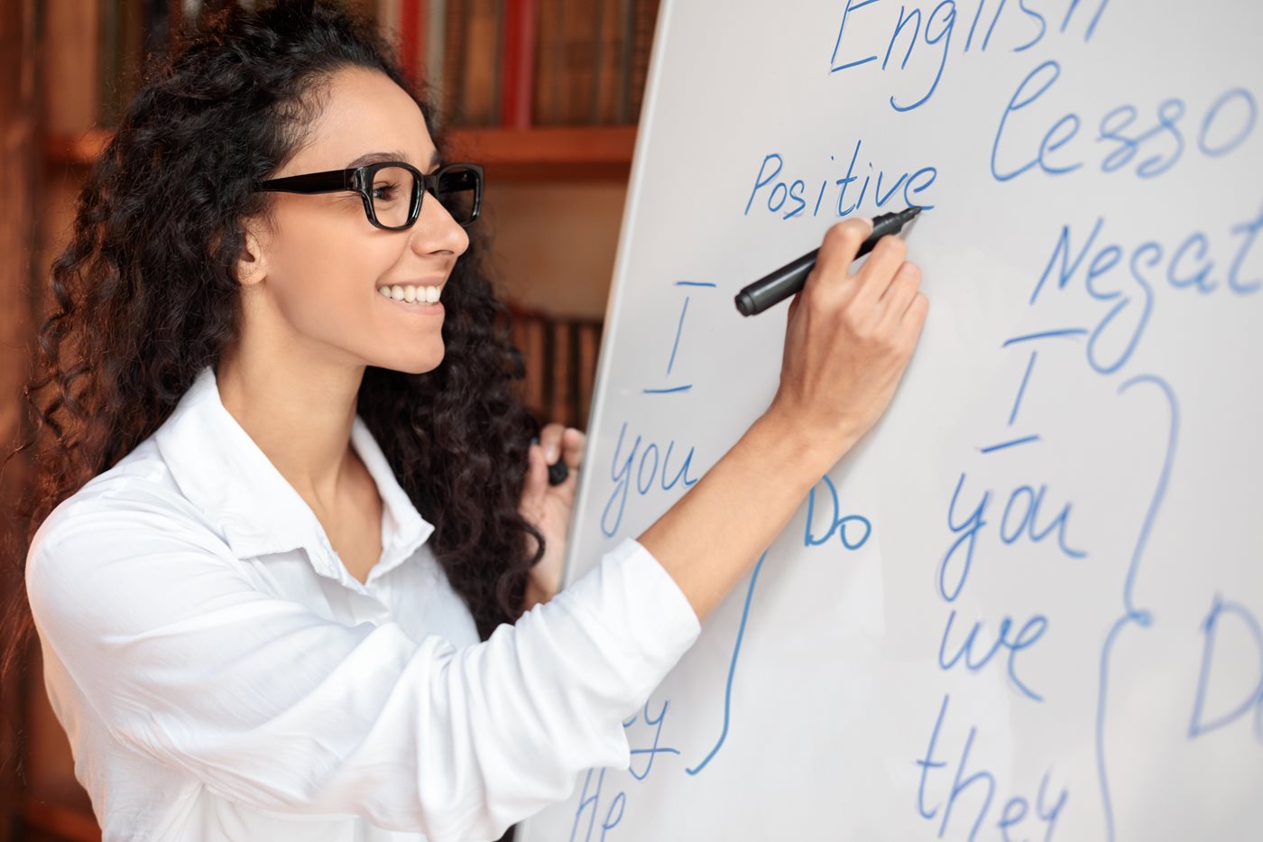 English teacher standing at whiteboard