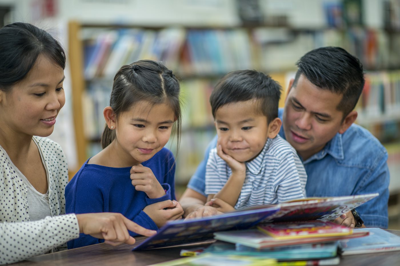 Asian family reading in library