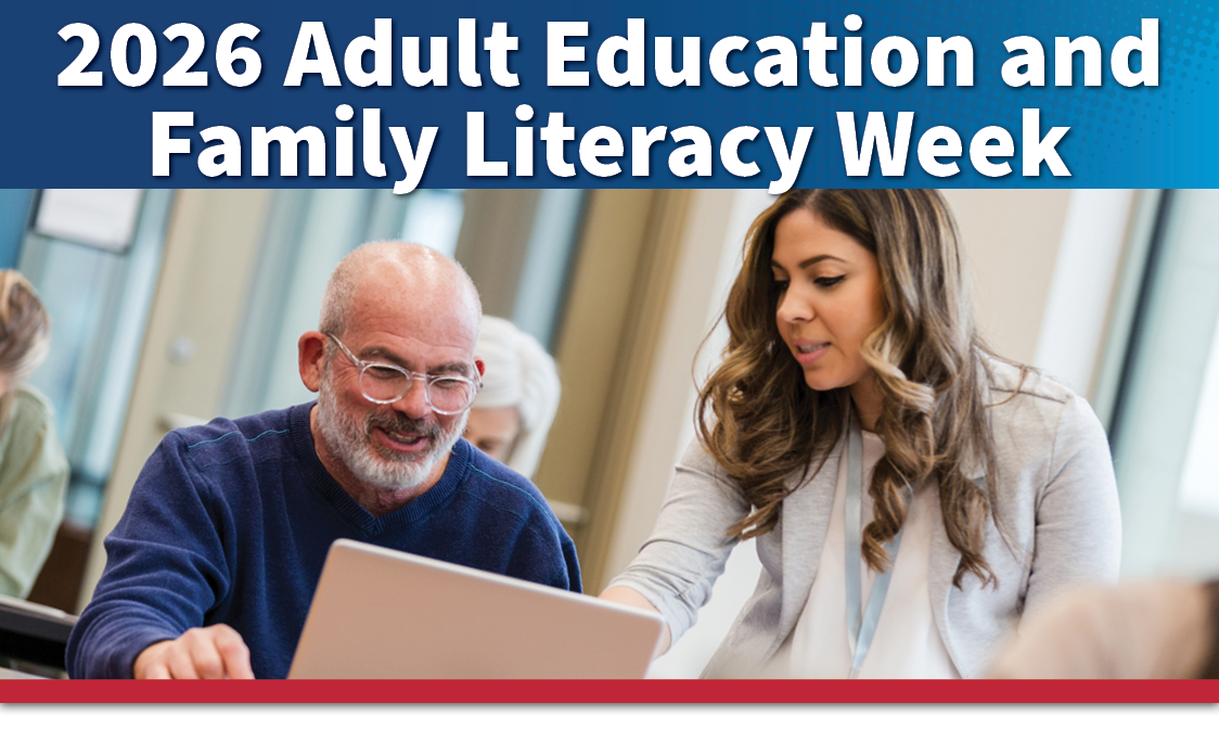 An adult male recieivng guidance from an adult female educator in a classroom setting